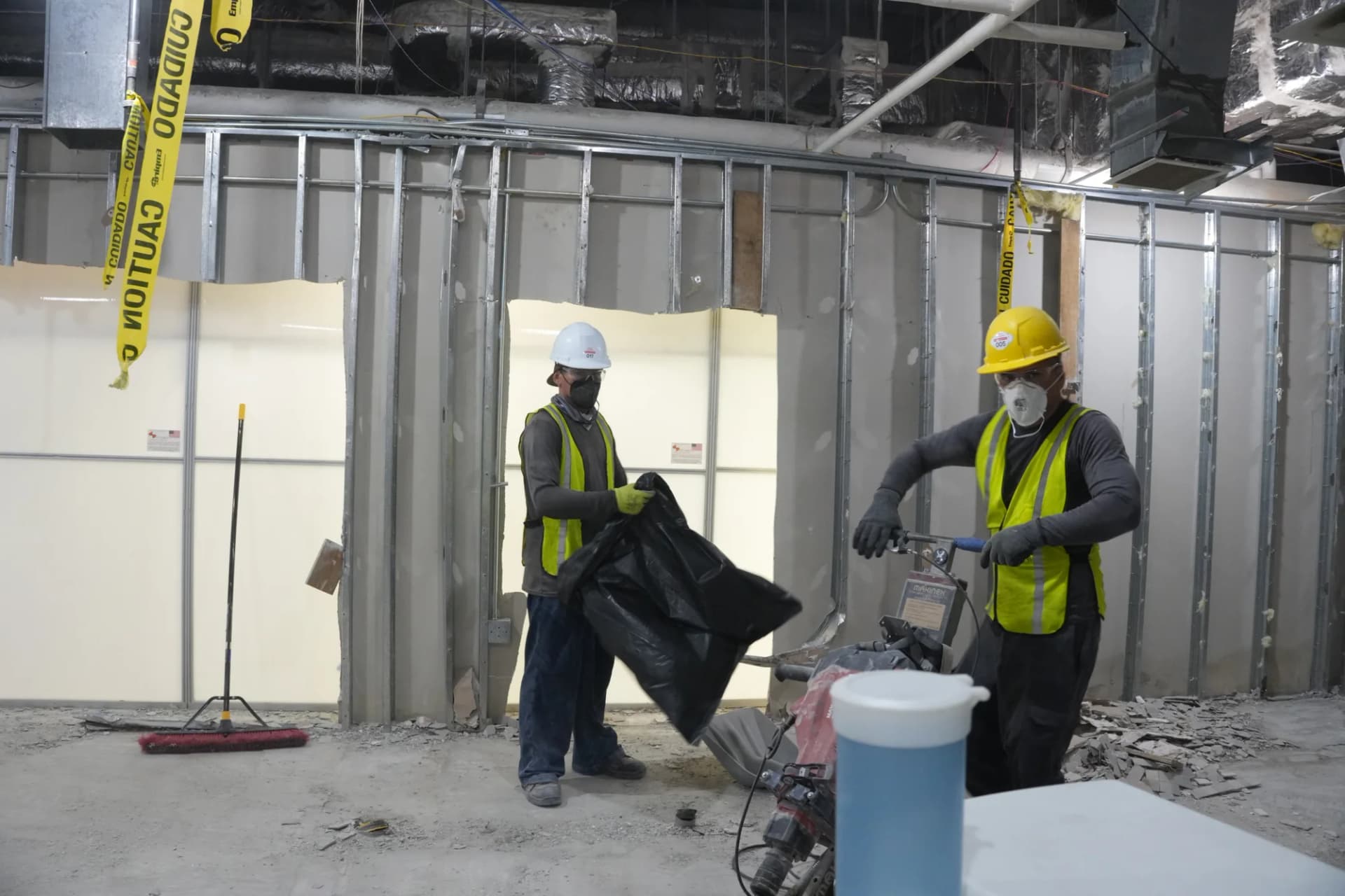 JZ crew removing flooring and bagging debris at MOB Pompano