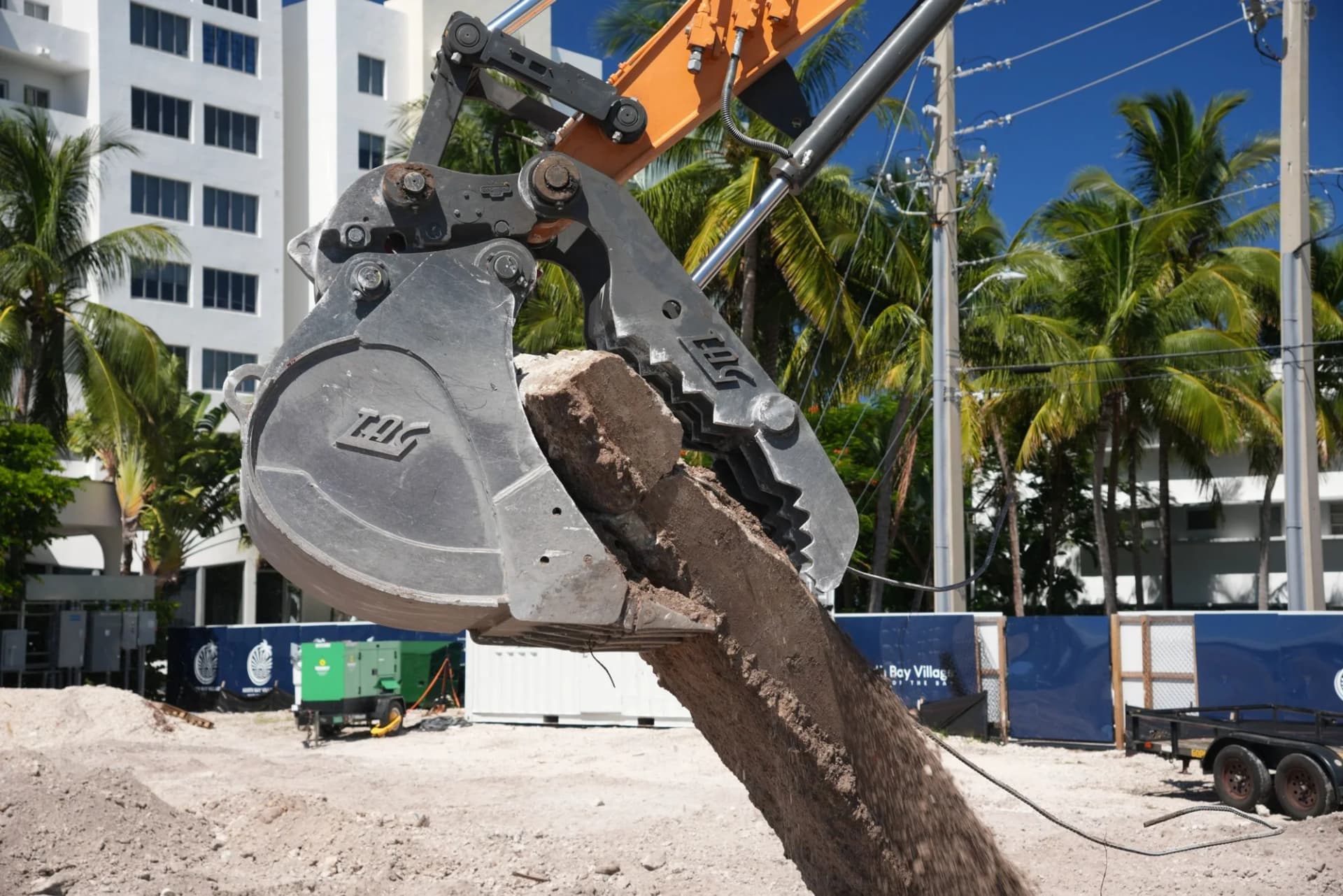 Excavator bucket holding broken material at the Pagani Residence jobsite