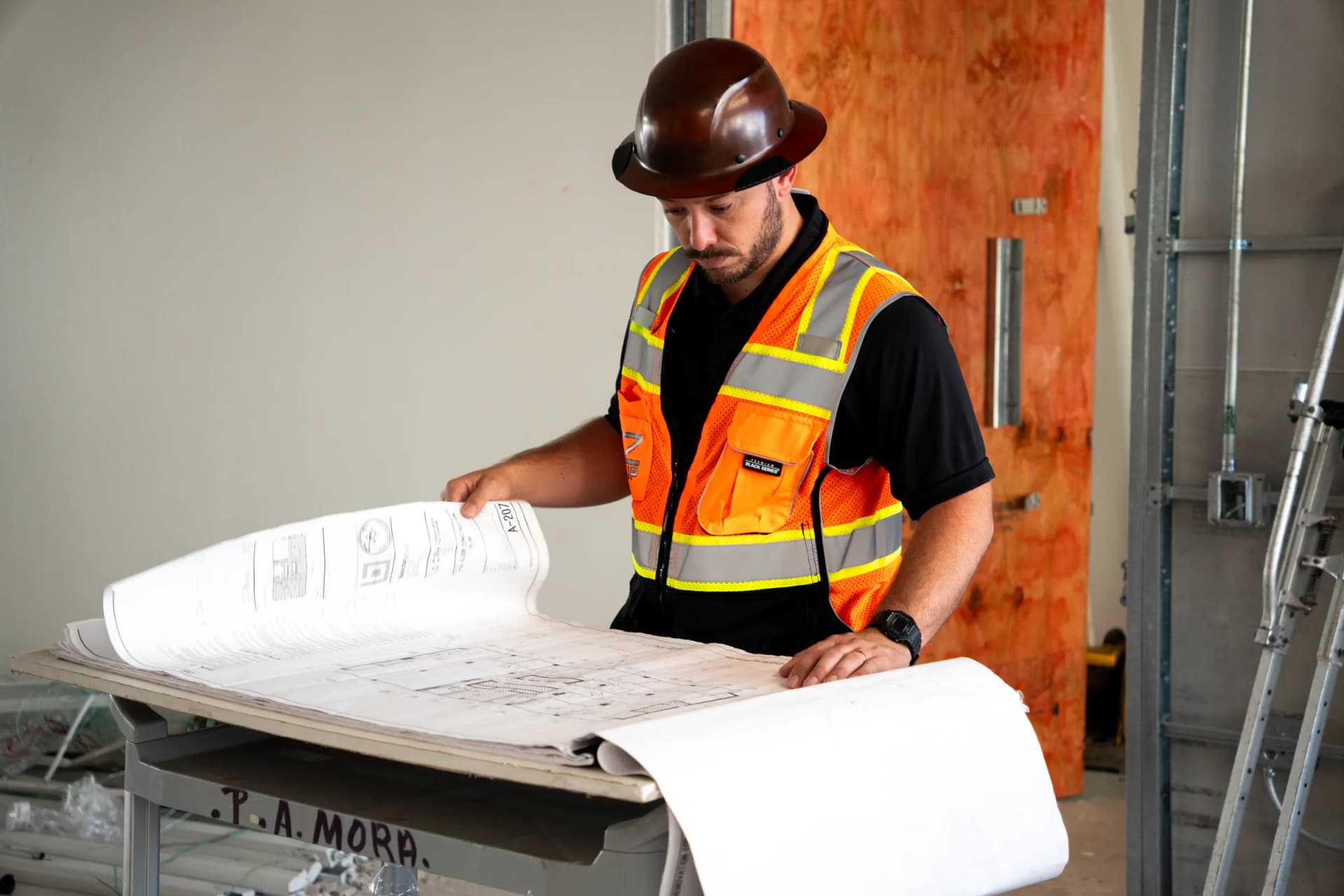 JZ team member reviewing a drawing set at 100 Biscayne